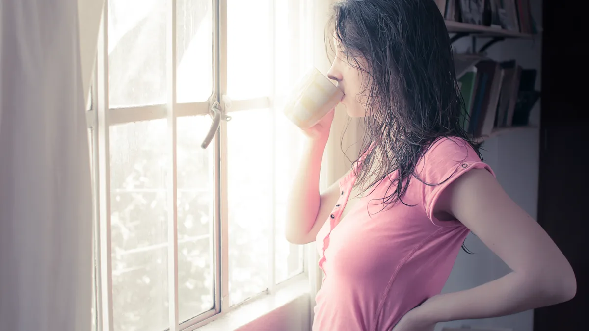 gentle breathwork for parents sitting peacefully by a sunny window