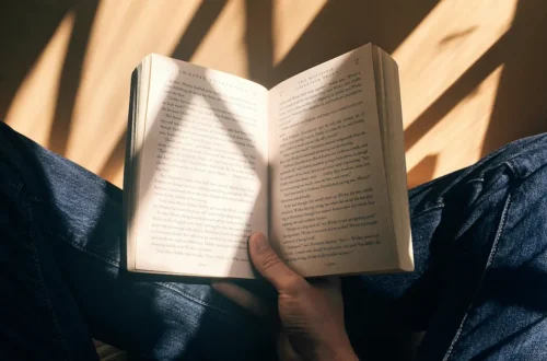 how to become a morning person: soft morning sunlight streaming through sheer curtains onto a wooden table