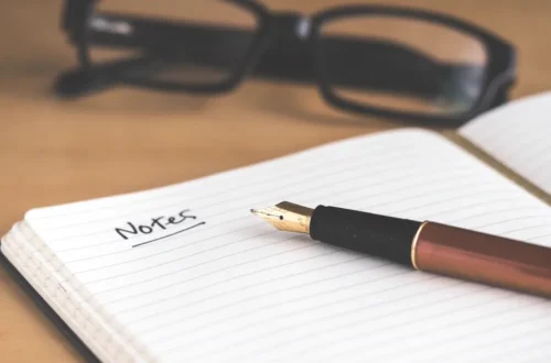 morning routine template: open daily planner notebook and pen resting on clean wooden desk